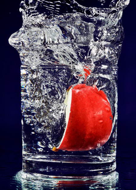Постер (плакат) Красное яблоко в стакане воды
